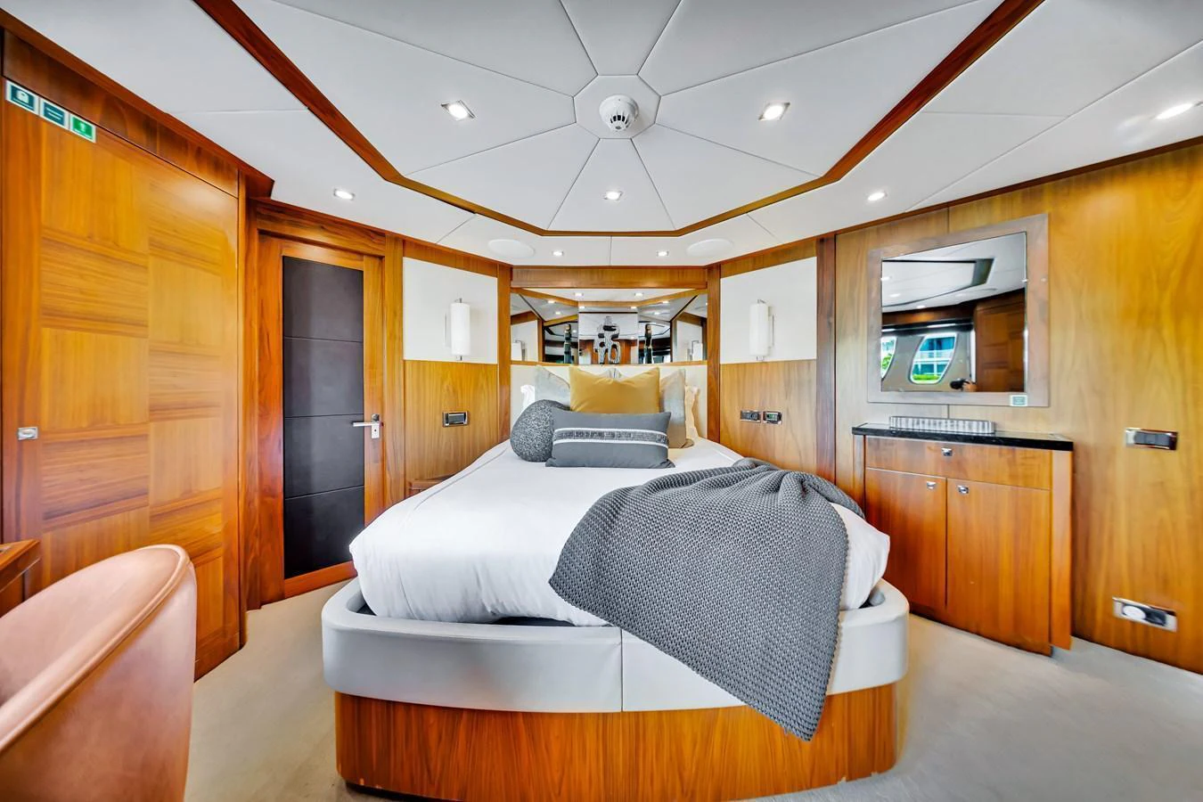 The master stateroom features a luxurious bed with elegant wood paneling and modern amenities. aboard NATURAL 9 Yacht for Sale