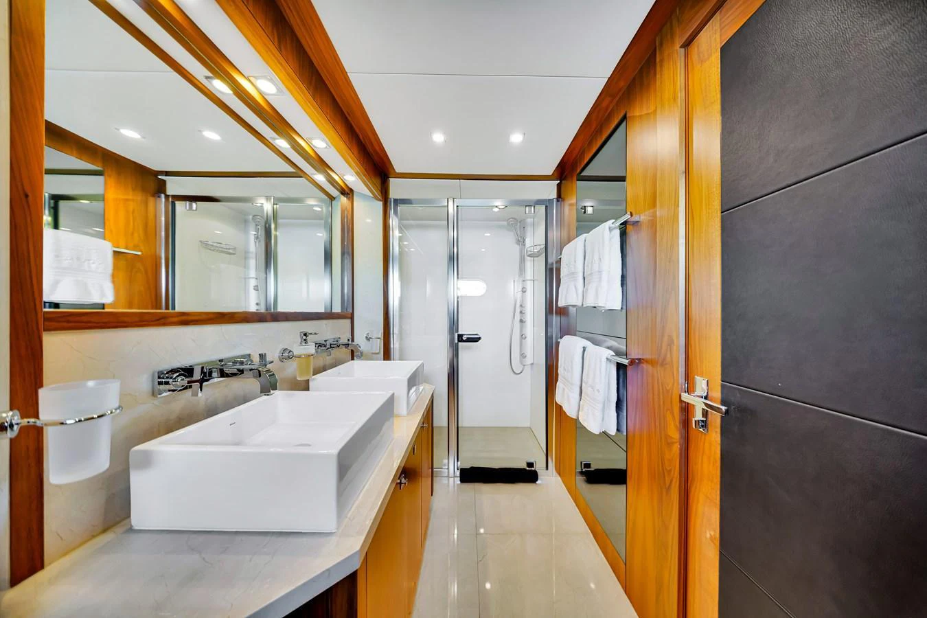 The yacht's bathroom features modern fixtures and a sleek design with ample lighting. aboard NATURAL 9 Yacht for Sale