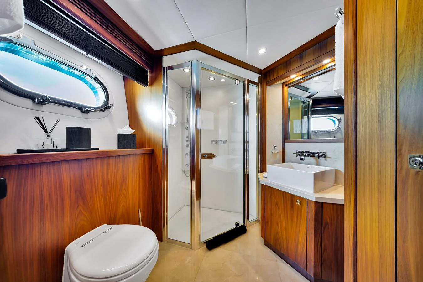 A luxurious yacht bathroom with wood accents and modern fixtures. aboard NATURAL 9 Yacht for Sale