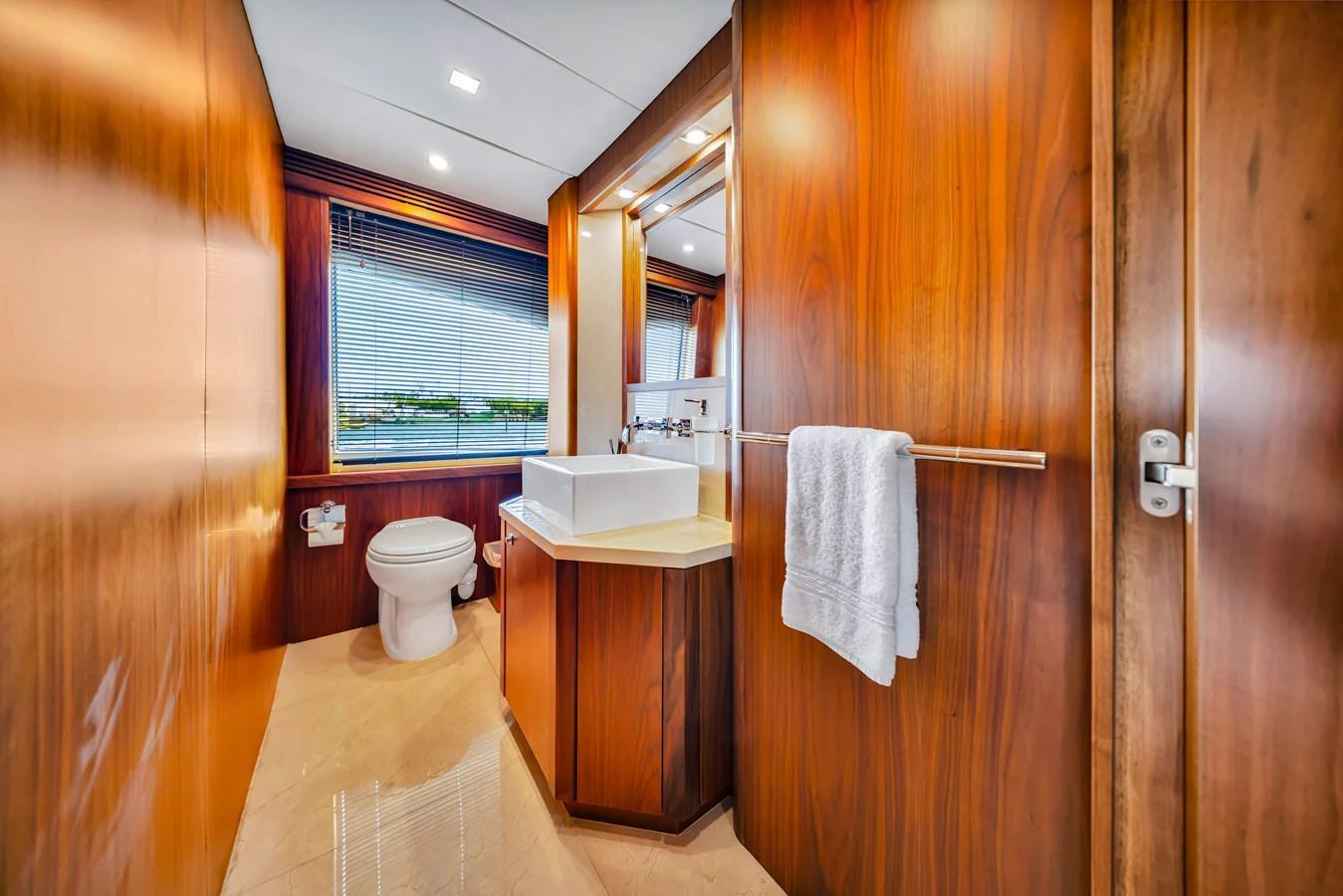 The yacht's bathroom features elegant wooden paneling and modern fixtures. aboard NATURAL 9 Yacht for Sale