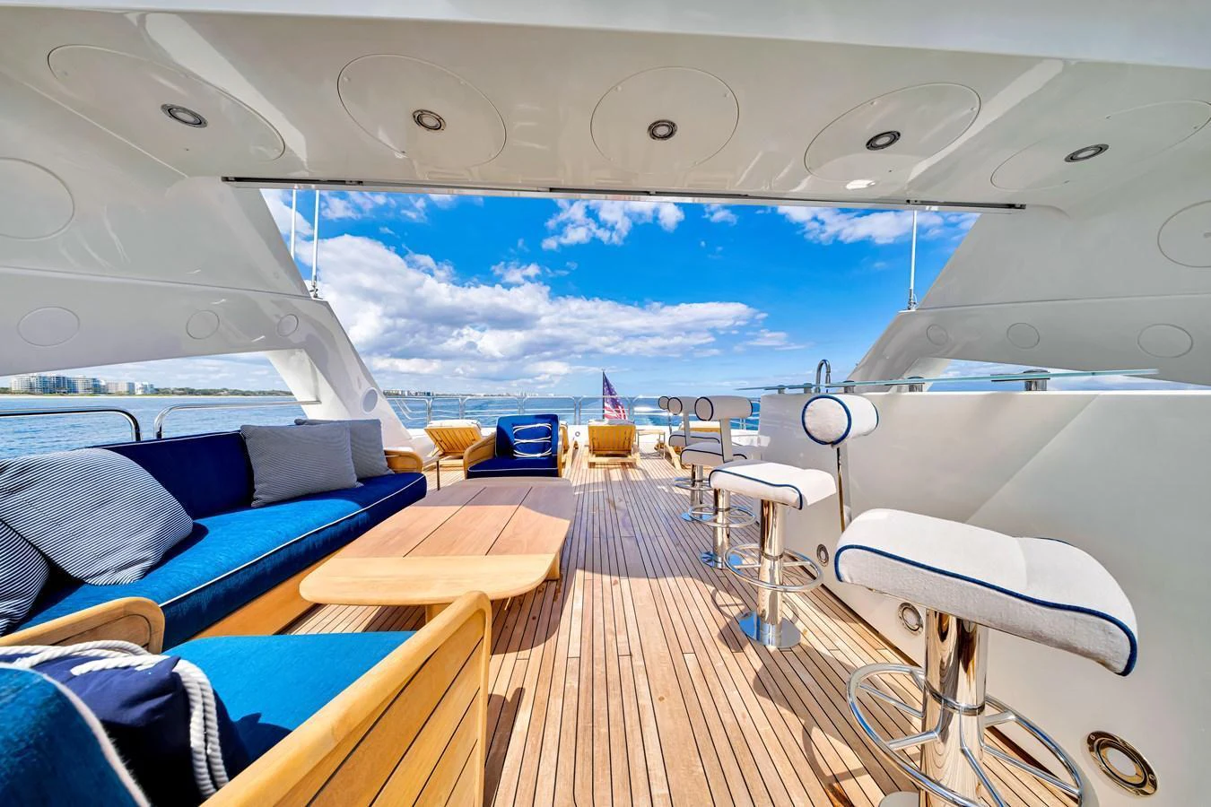 The yacht's aft deck features comfortable seating and a bar area, perfect for enjoying the open sea views. aboard NATURAL 9 Yacht for Sale