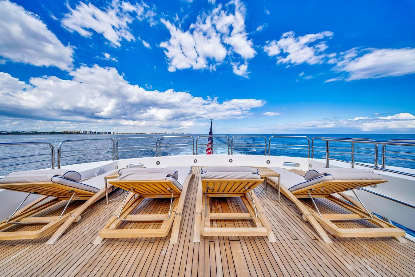 The sundeck offers a serene space with luxurious sun loungers and a stunning ocean view. aboard NATURAL 9 Yacht for Sale