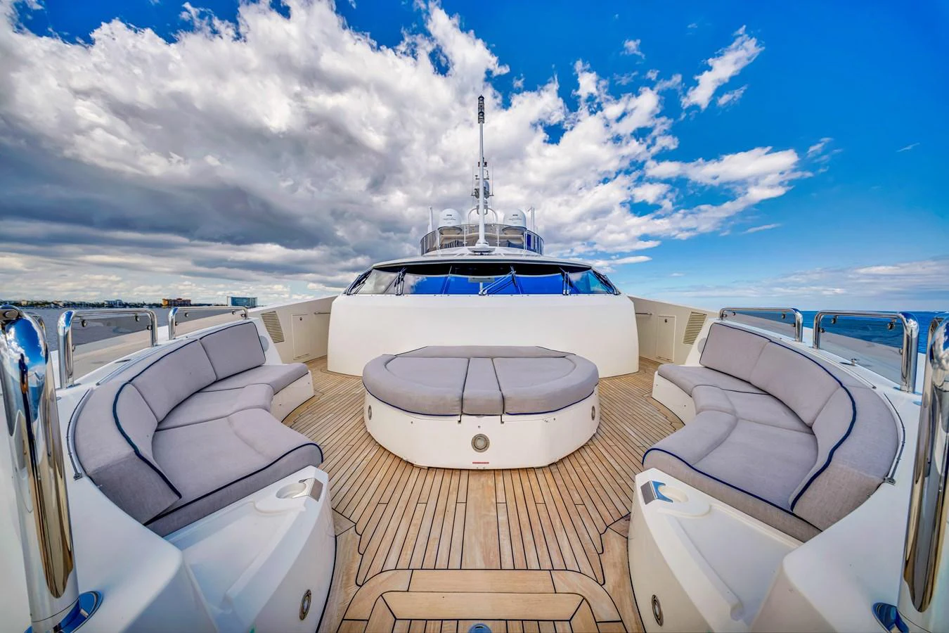 The yacht features a spacious bow seating area with plush cushions and a central table, perfect for relaxation and socializing. aboard NATURAL 9 Yacht for Sale