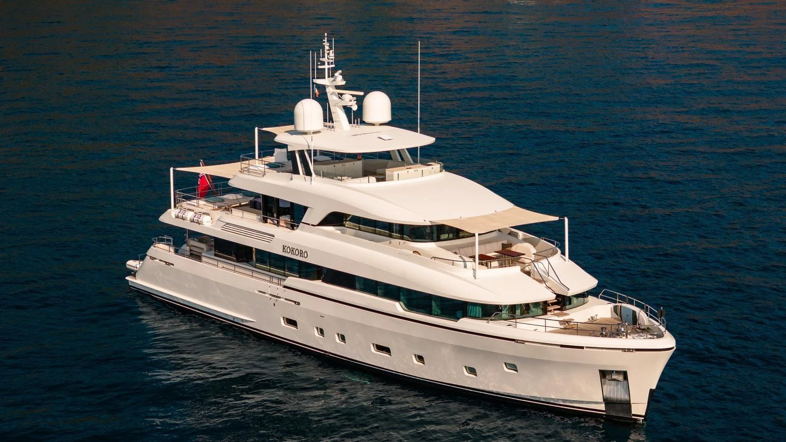 A luxurious yacht cruises gracefully on calm waters, showcasing its elegant design and spacious decks. aboard KOKORO Yacht for Sale