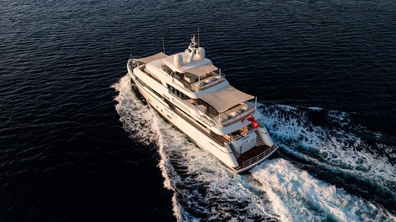 A luxurious yacht cruises through the open sea, showcasing its elegant design and spacious decks. aboard KOKORO Yacht for Sale