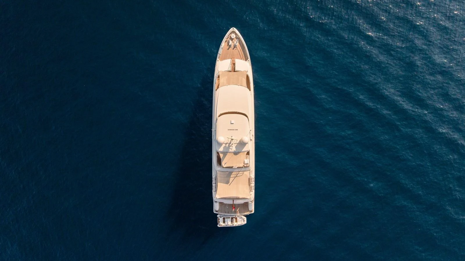 Aerial view of a luxurious yacht cruising on calm blue waters. aboard KOKORO Yacht for Sale