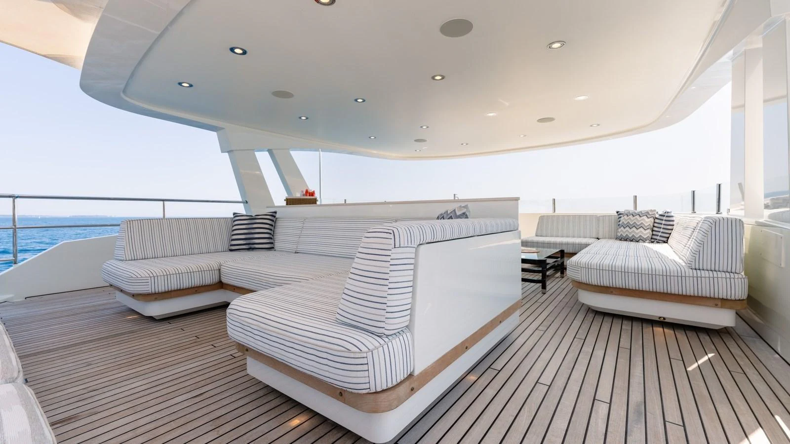 The sundeck features luxurious, spacious seating with a stunning view of the sea. aboard KOKORO Yacht for Sale