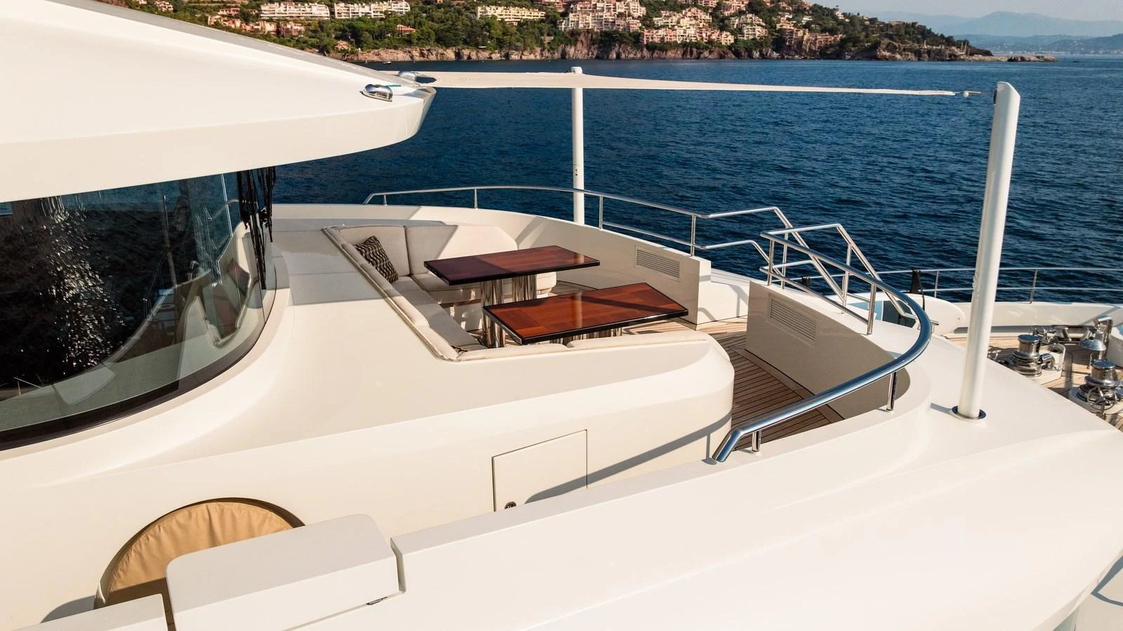 The upper deck of the yacht offers a luxurious space with seating and dining areas overlooking the serene waters. aboard KOKORO Yacht for Sale