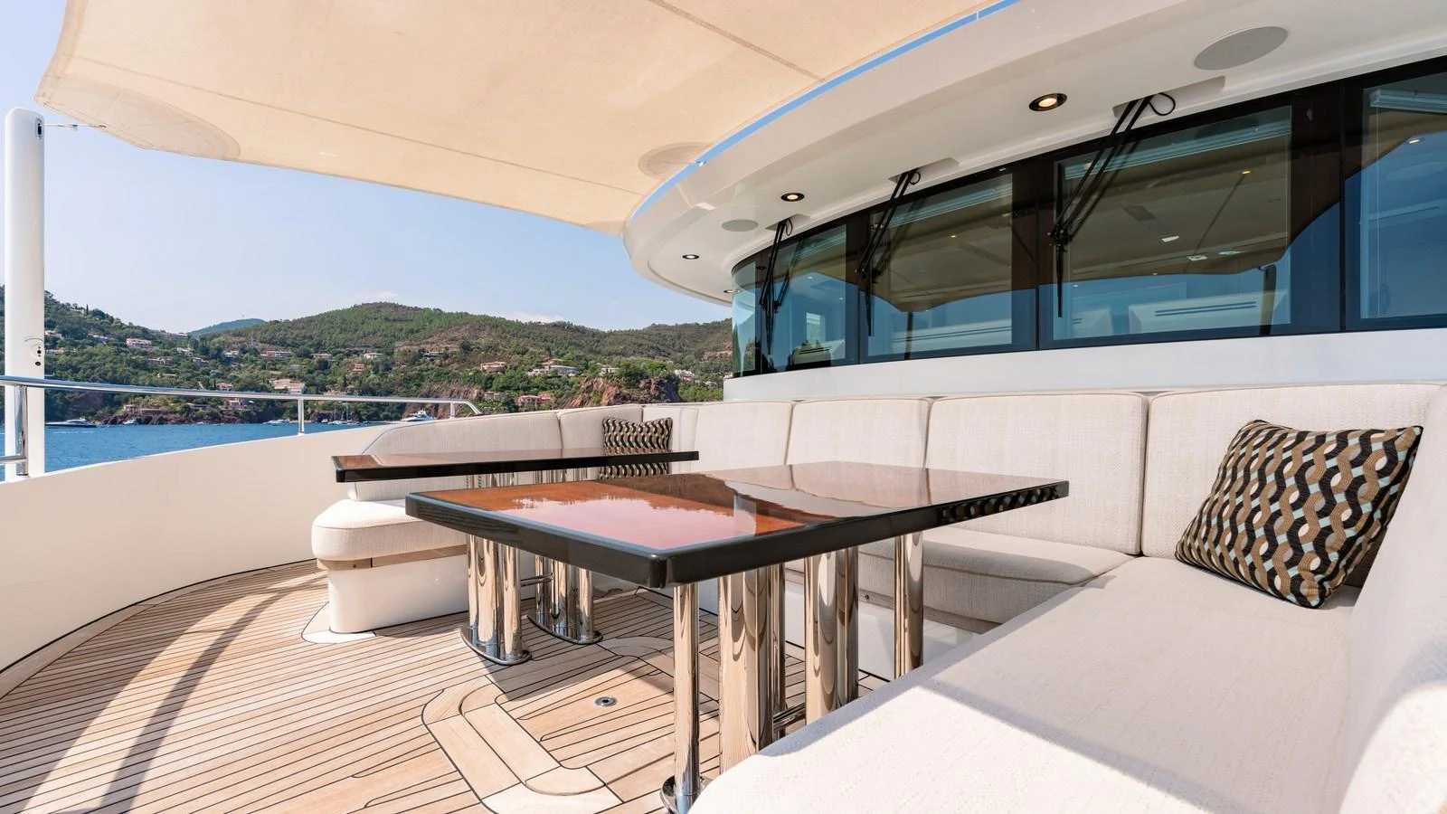 The aft deck features a spacious seating area with elegant tables and a scenic view. aboard KOKORO Yacht for Sale