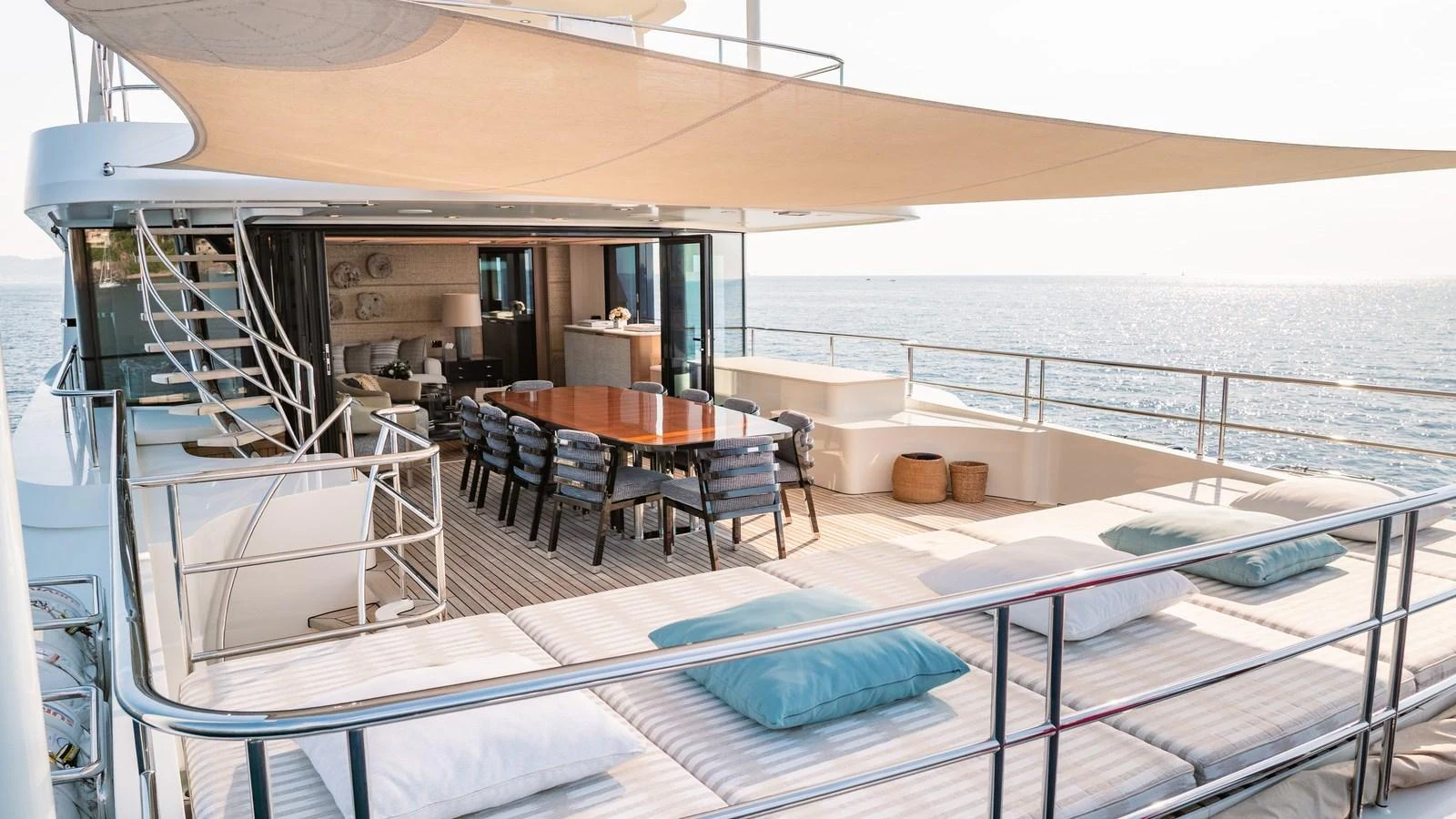 The aft deck offers a spacious and luxurious outdoor dining and lounging area with stunning ocean views. aboard KOKORO Yacht for Sale