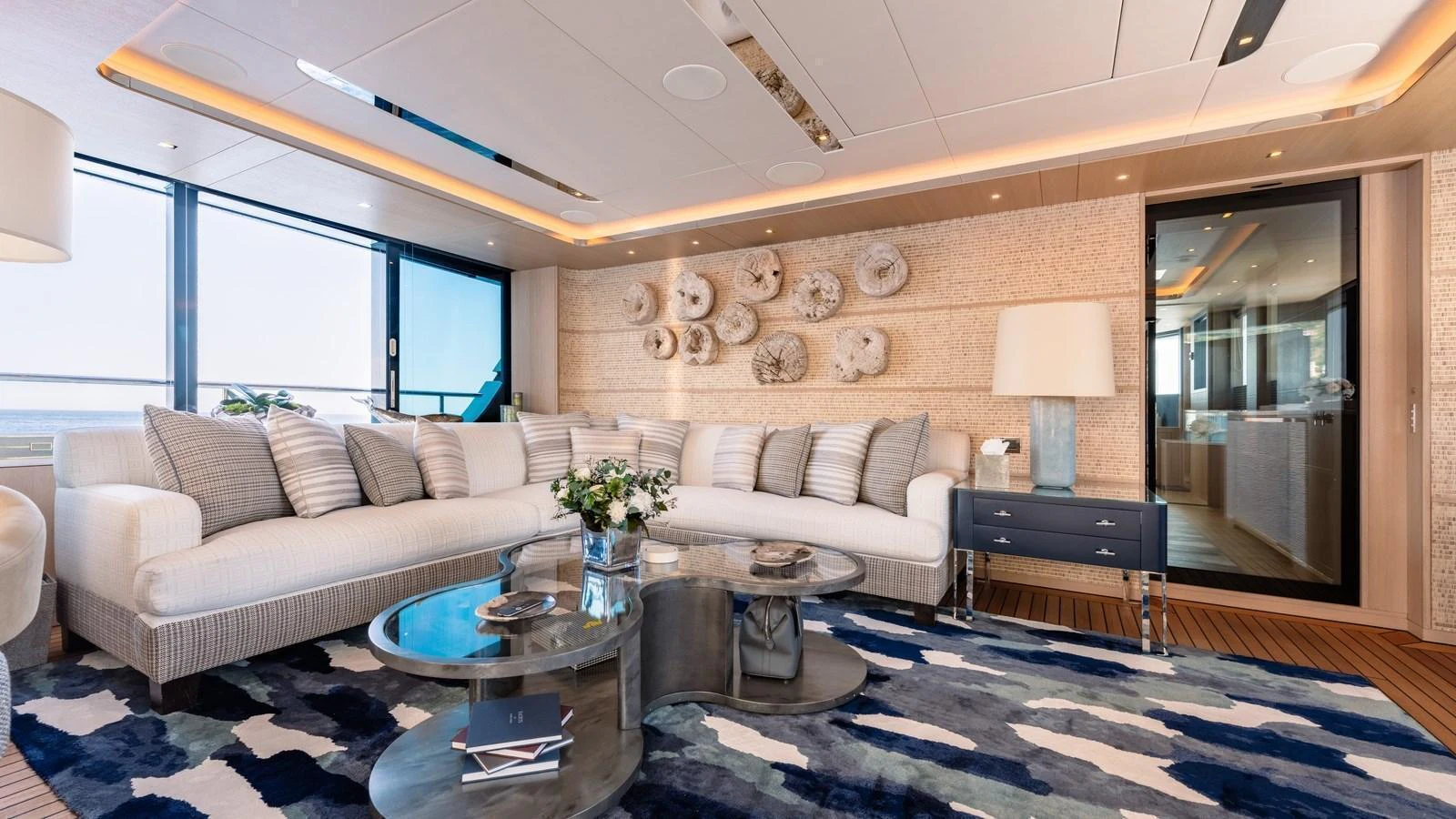 The salon features a spacious seating area with modern decor and large windows offering stunning views. aboard KOKORO Yacht for Sale