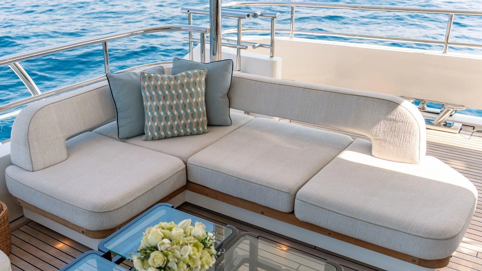 The aft deck features a comfortable and stylish seating area with a view of the ocean. aboard KOKORO Yacht for Sale