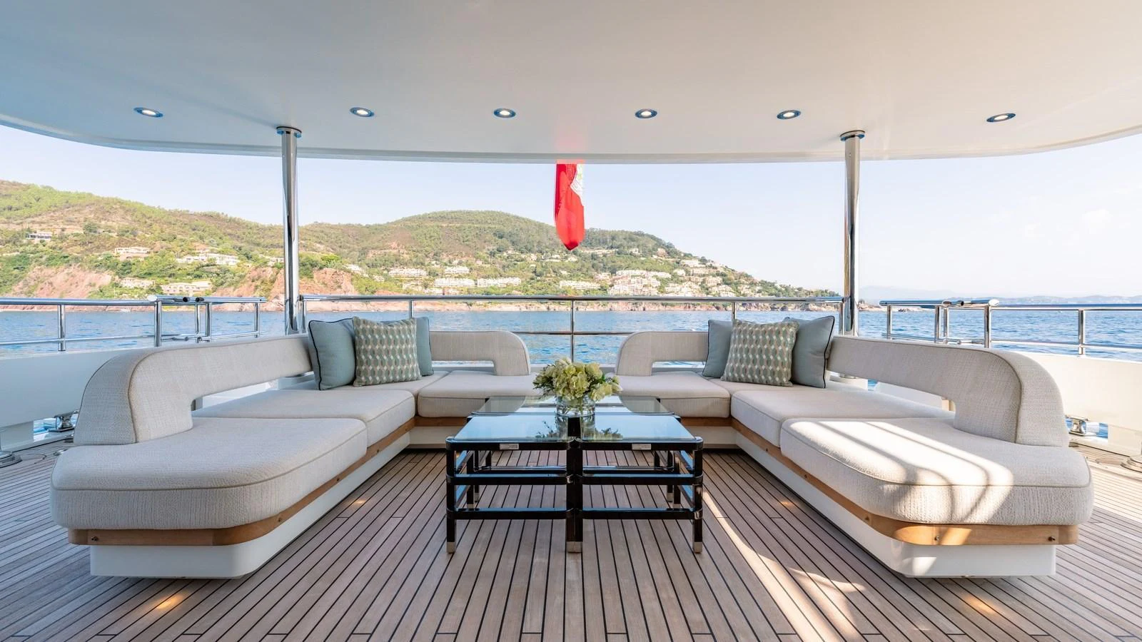 The aft deck features a spacious and elegant seating area with a stunning view of the sea. aboard KOKORO Yacht for Sale