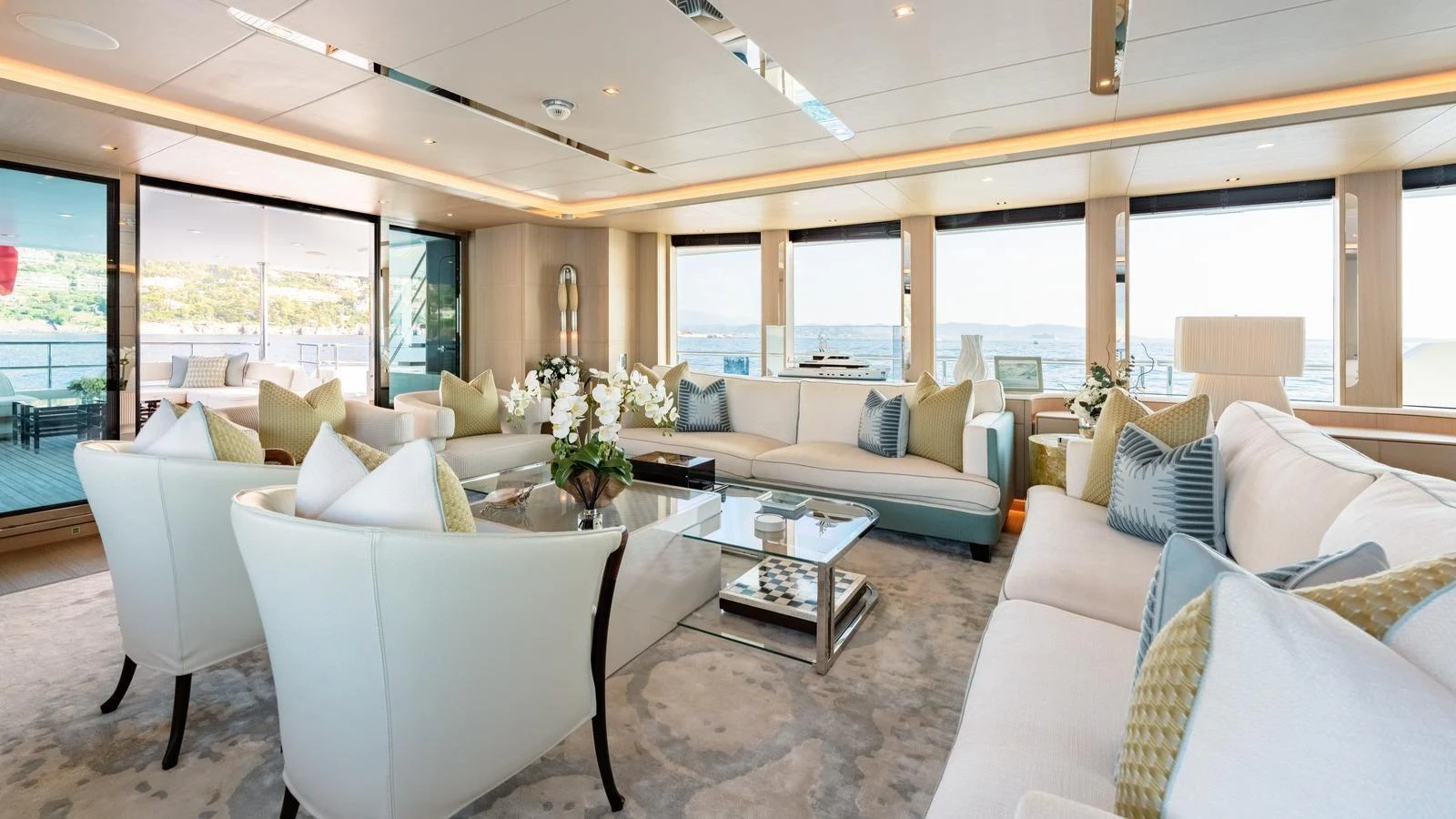 The spacious salon features elegant seating with panoramic views through large windows. aboard KOKORO Yacht for Sale