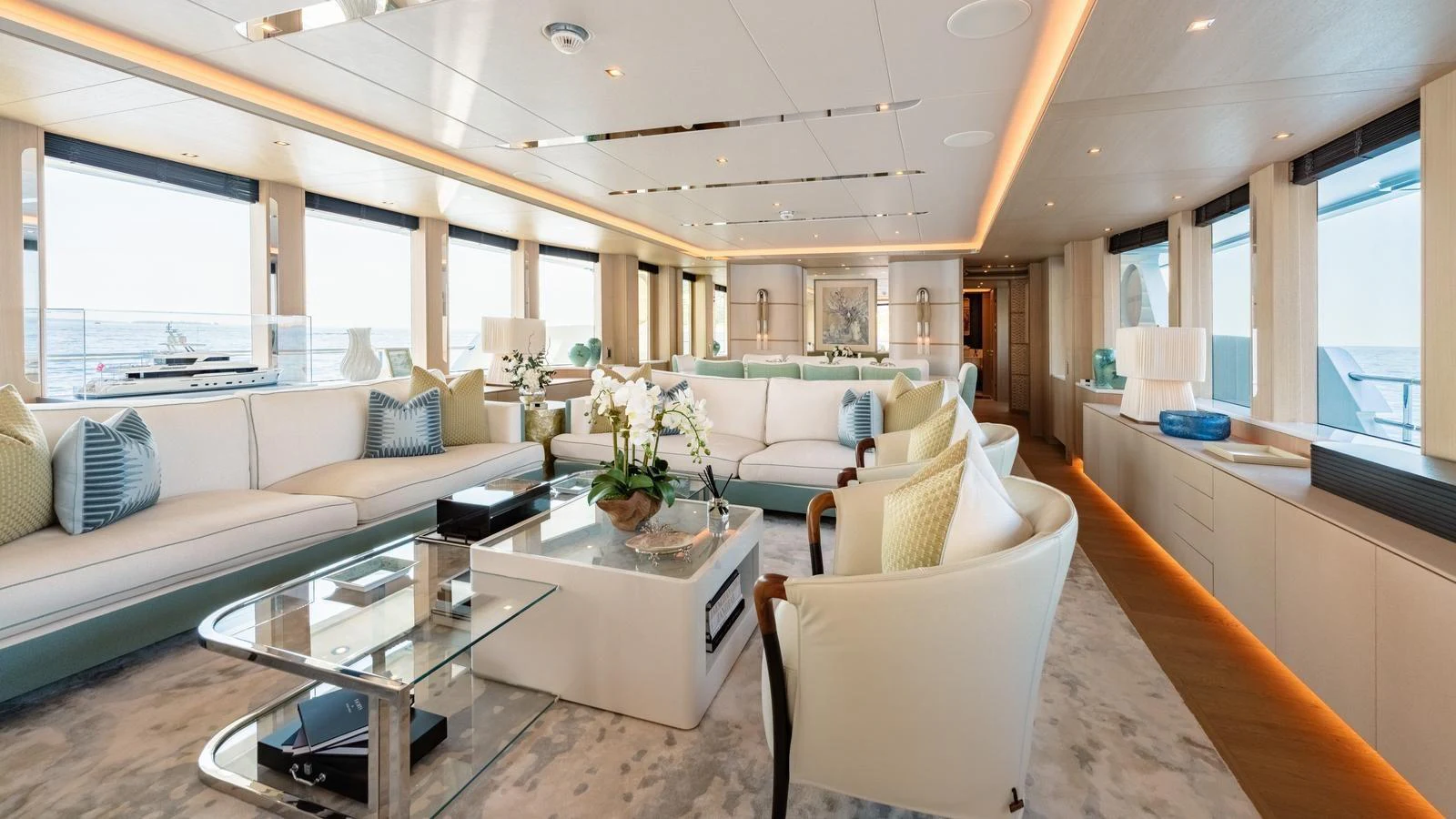 The spacious salon features elegant seating, large windows, and modern decor, offering a luxurious and comfortable environment. aboard KOKORO Yacht for Sale