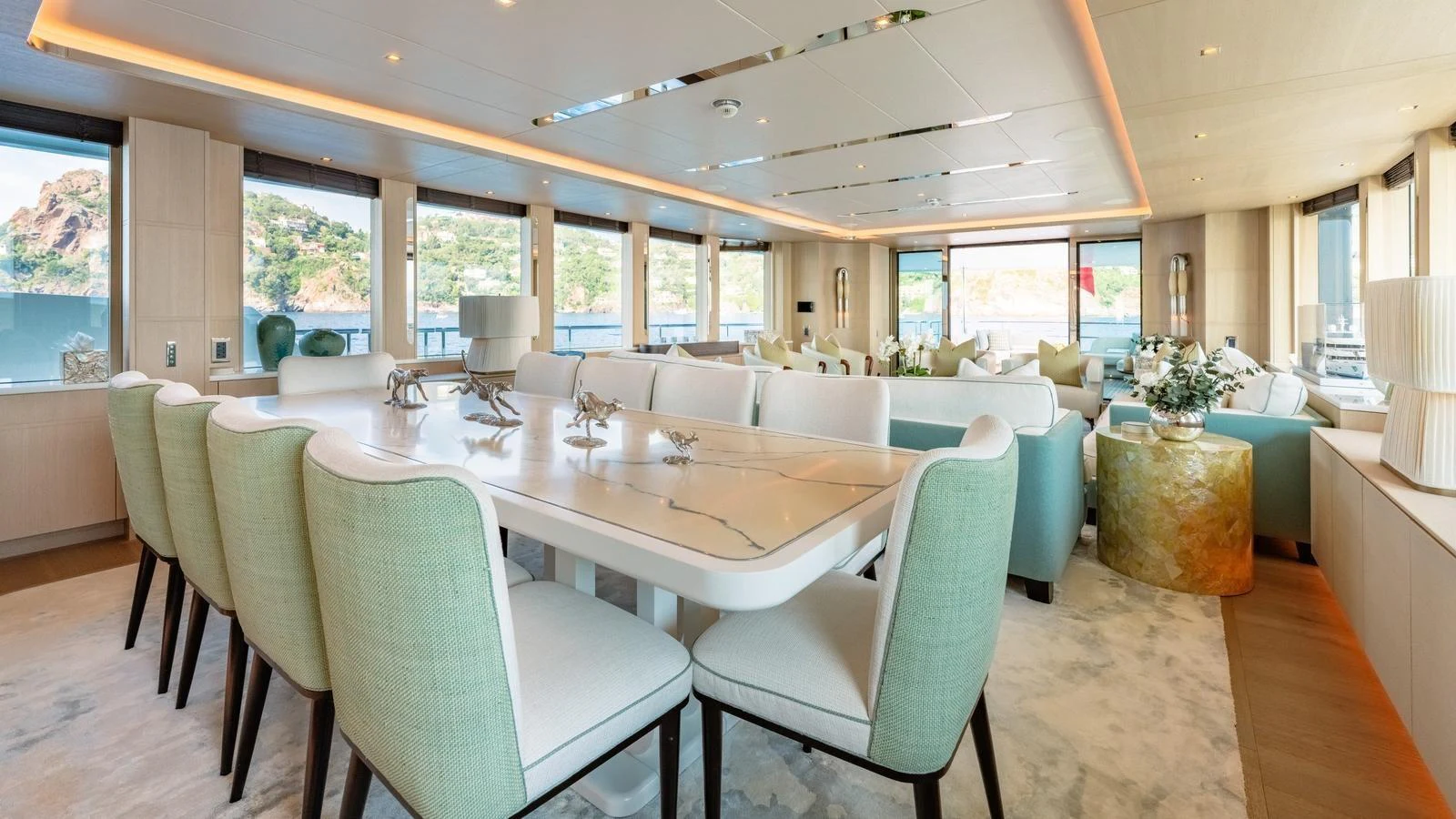 The yacht's dining area features a spacious table with elegant seating and panoramic windows offering stunning views. aboard KOKORO Yacht for Sale