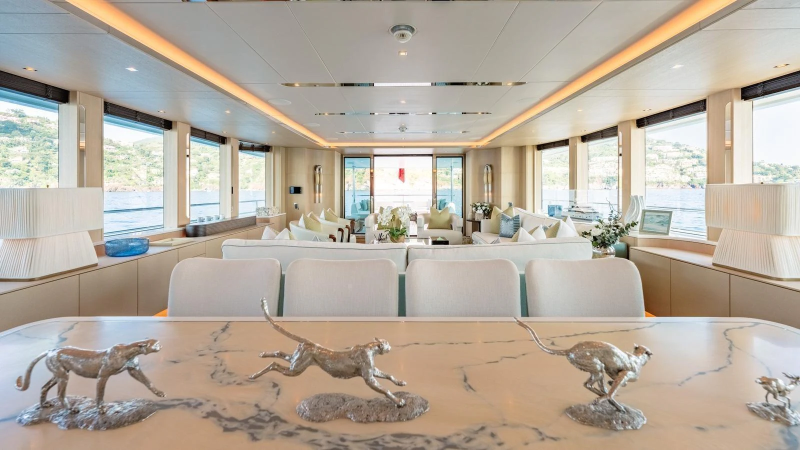 The spacious salon features elegant decor with panoramic windows offering stunning views. aboard KOKORO Yacht for Sale