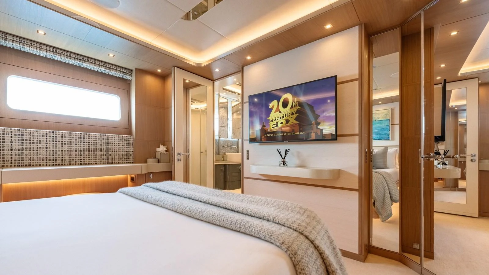 The master stateroom features a luxurious bed, modern decor, and ample natural light. aboard KOKORO Yacht for Sale