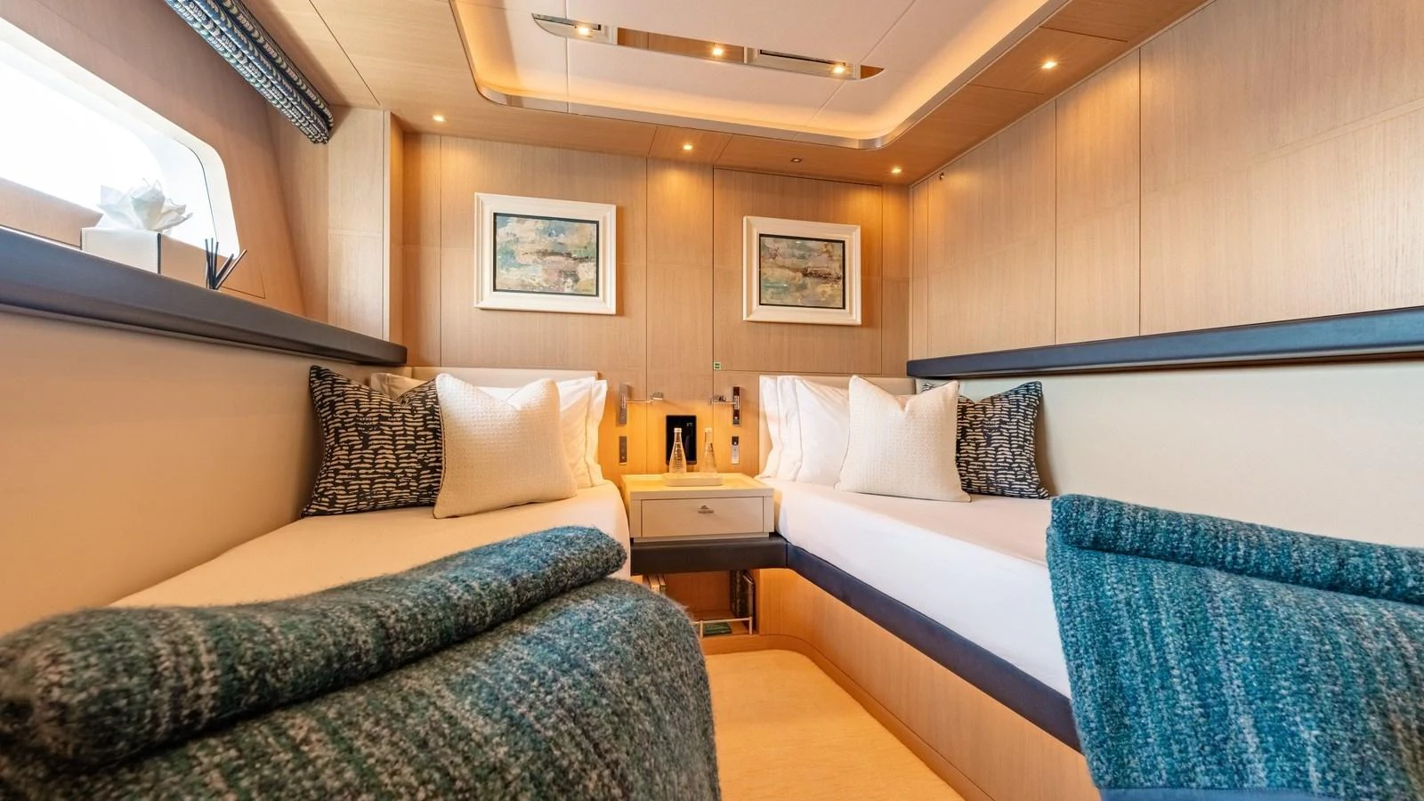 The guest stateroom features twin beds with elegant decor and ample natural light. aboard KOKORO Yacht for Sale