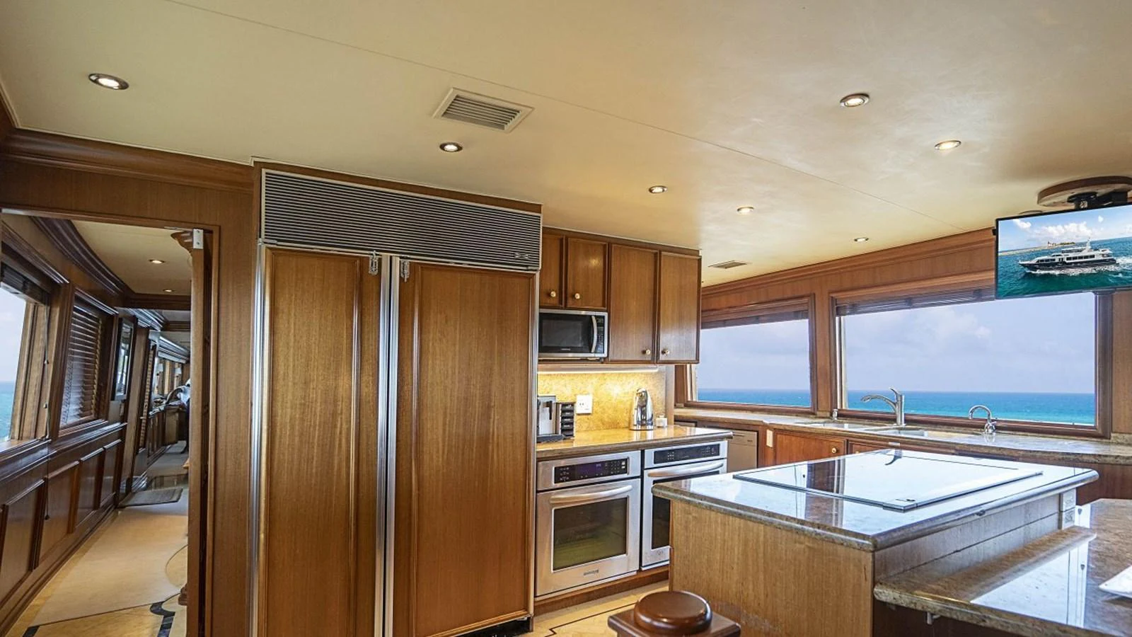 The galley features modern appliances and a stunning ocean view through large windows. aboard TRUE NORTH Yacht for Sale