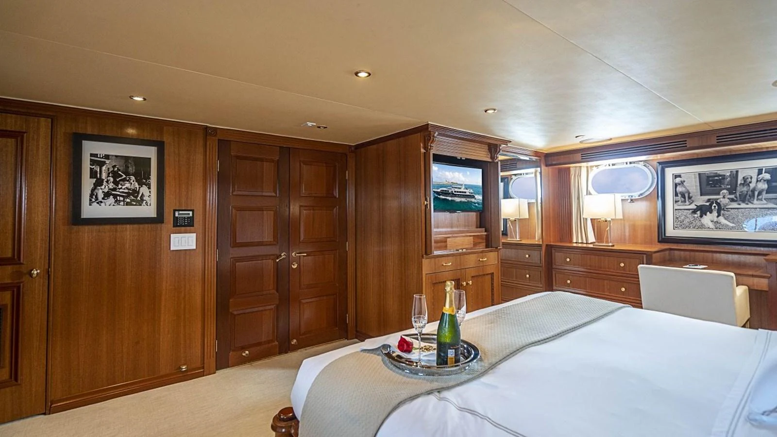 The master stateroom features elegant wood paneling and luxurious amenities for a comfortable stay. aboard TRUE NORTH Yacht for Sale