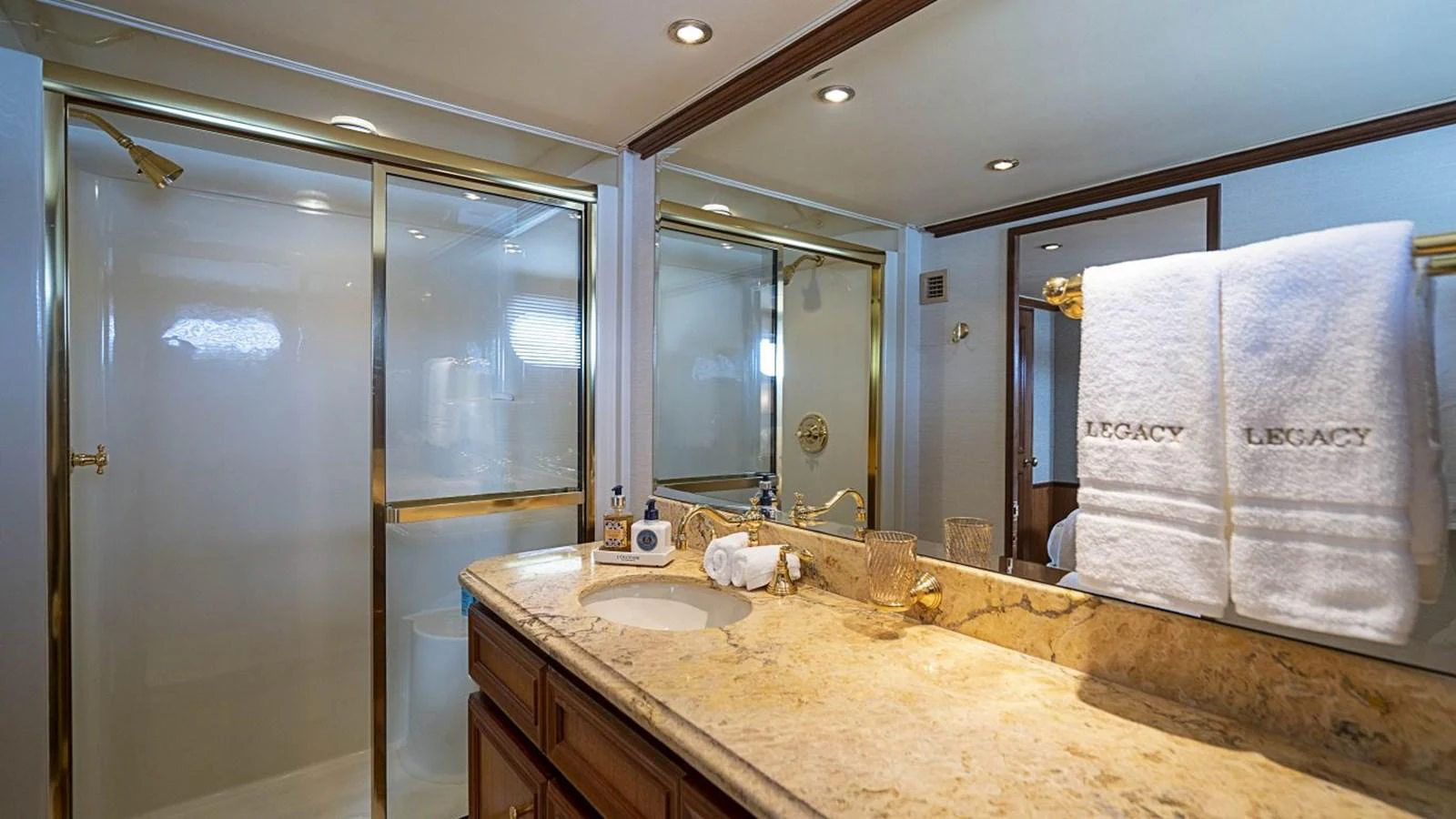 A luxurious bathroom with a marble countertop and gold accents. aboard TRUE NORTH Yacht for Sale