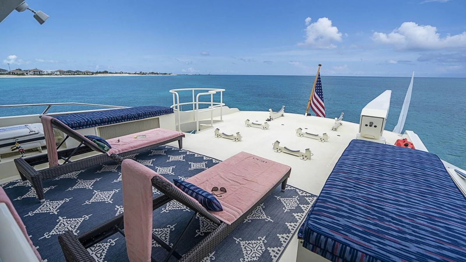 The sundeck offers a relaxing space with sun loungers and stunning ocean views. aboard TRUE NORTH Yacht for Sale