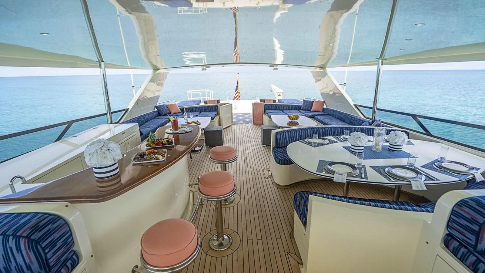 The flybridge offers a spacious and elegant dining and lounging area with stunning ocean views. aboard TRUE NORTH Yacht for Sale