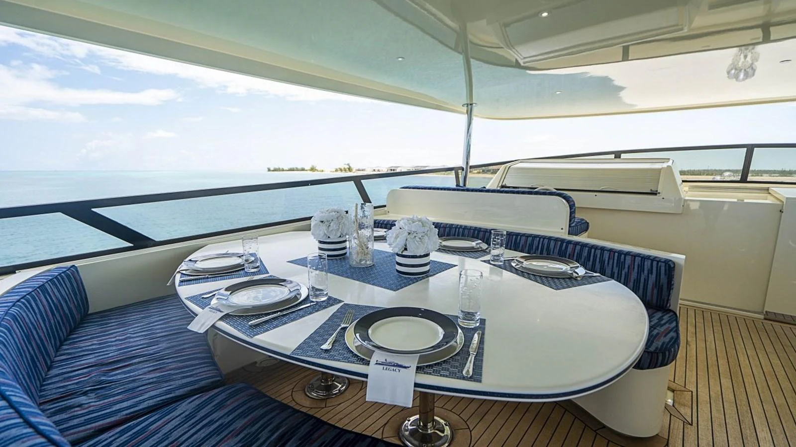 The yacht features an elegant alfresco dining area with a stunning ocean view. aboard TRUE NORTH Yacht for Sale
