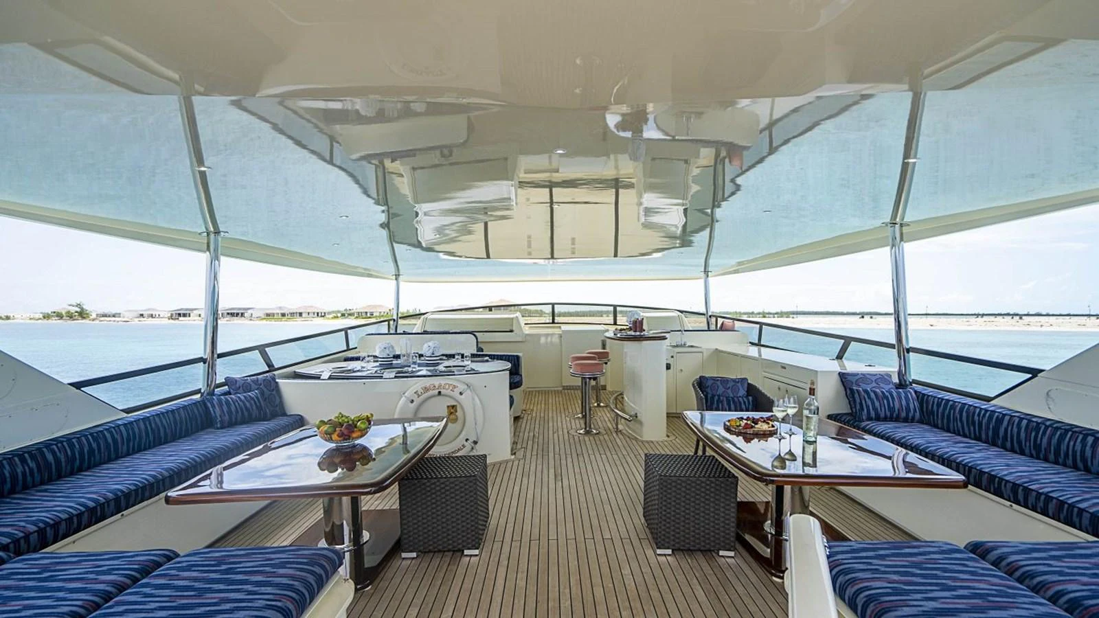 The spacious aft deck features elegant dining and lounging areas with panoramic views. aboard TRUE NORTH Yacht for Sale