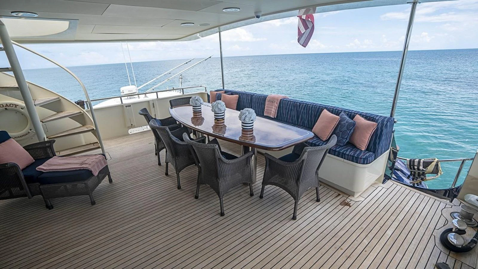 The aft deck offers a spacious and comfortable outdoor dining area with stunning ocean views. aboard TRUE NORTH Yacht for Sale