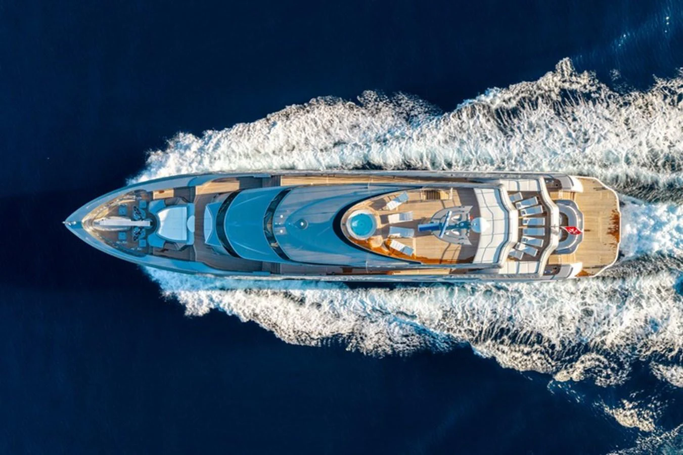 A stunning aerial view of a luxurious yacht cruising through the deep blue sea. aboard ANTALIS Yacht for Sale