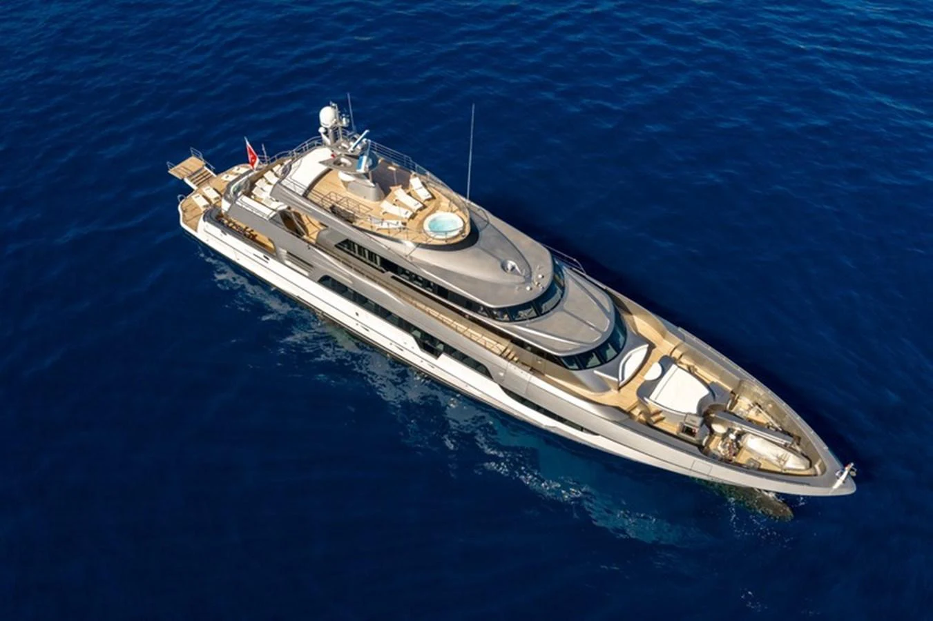 A sleek and luxurious yacht cruising on the open sea, showcasing its elegant design and spacious deck areas. aboard ANTALIS Yacht for Sale