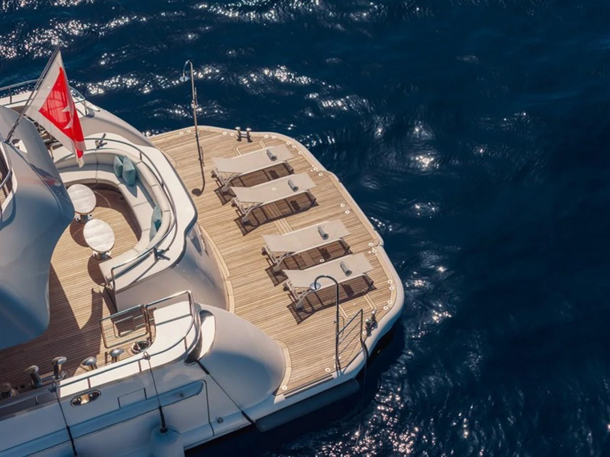 The aft deck features a spacious sunbathing area with lounge chairs and a teak deck, perfect for relaxation. aboard ANTALIS Yacht for Sale