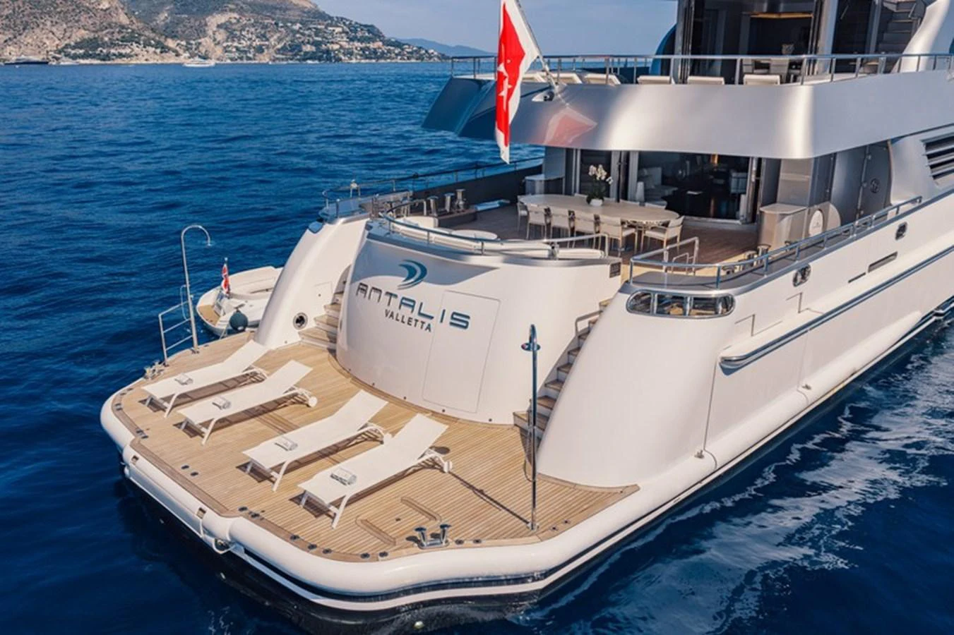 The yacht's spacious aft deck features sun loungers and a swim platform, perfect for relaxation and water activities. aboard ANTALIS Yacht for Sale