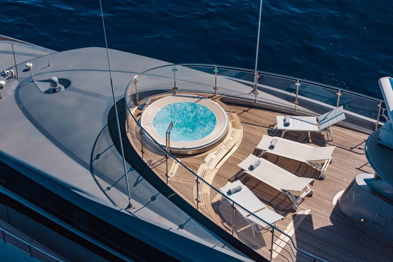 The sundeck features a luxurious jacuzzi surrounded by sun loungers, offering a perfect relaxation spot with stunning sea views. aboard ANTALIS Yacht for Sale