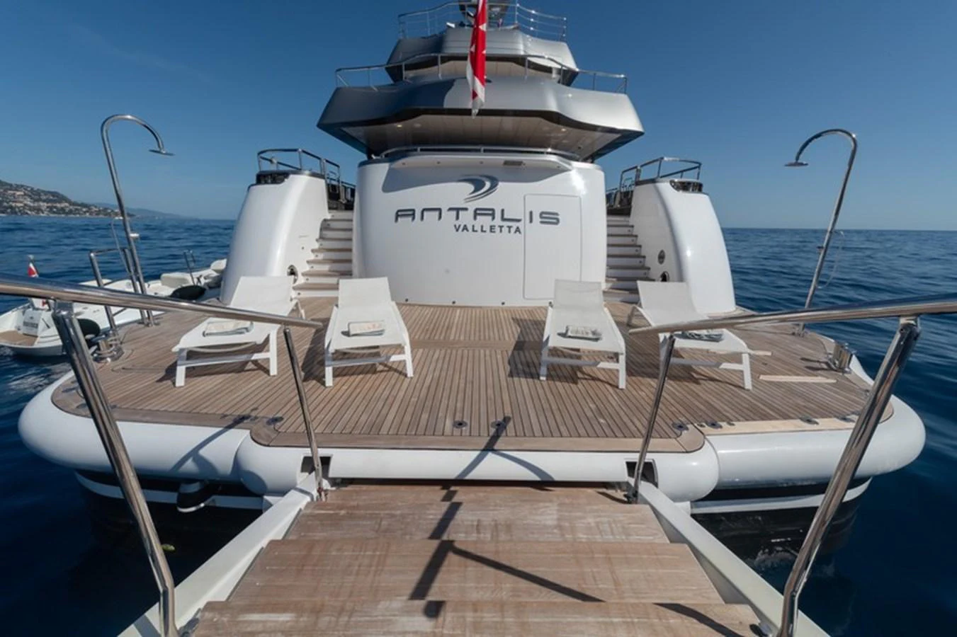 The aft deck of the yacht features a spacious lounging area with sunbeds and direct access to the water. aboard ANTALIS Yacht for Sale