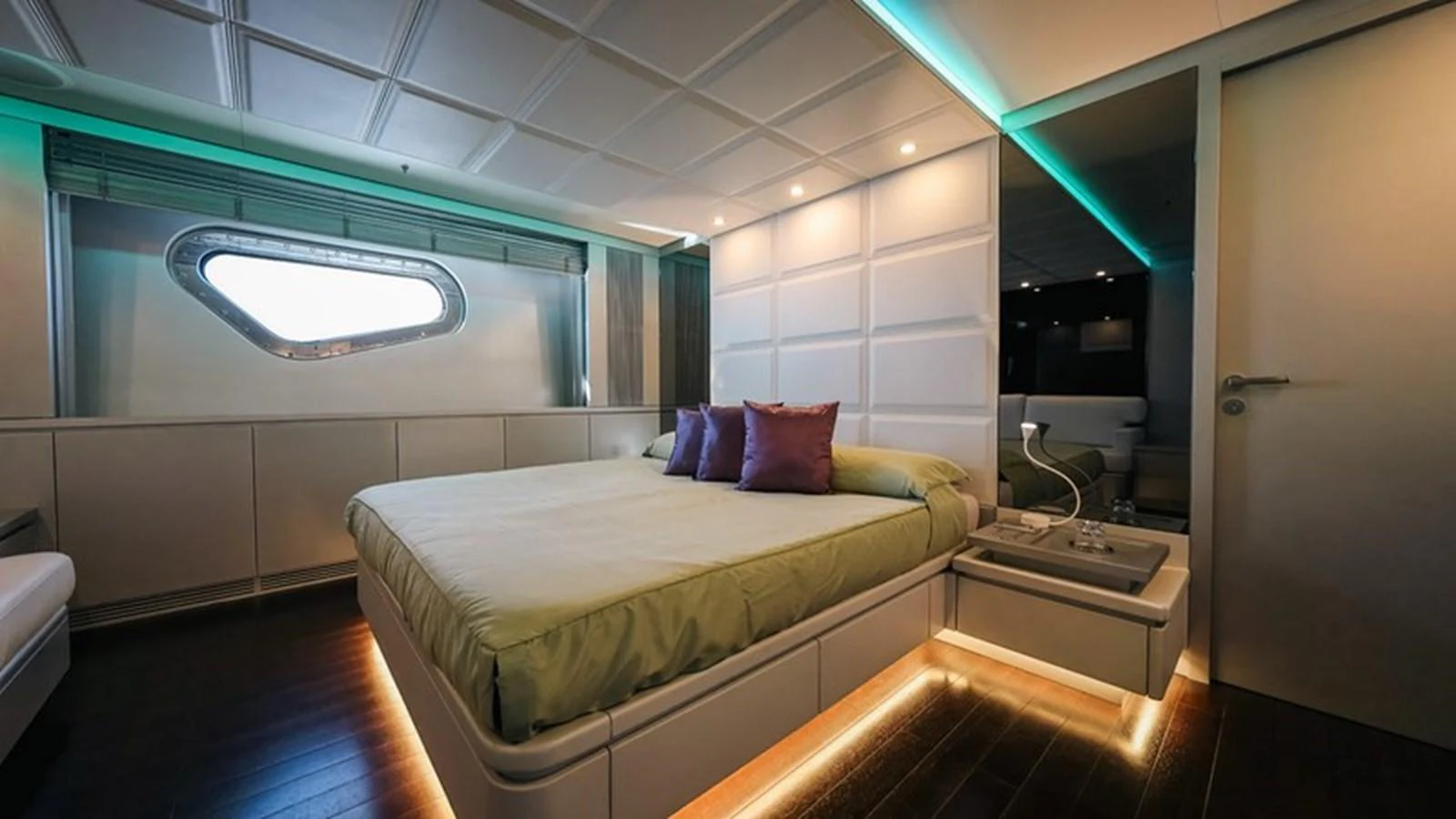 A luxurious stateroom featuring a large bed with ambient lighting and modern decor. aboard ANTALIS Yacht for Sale
