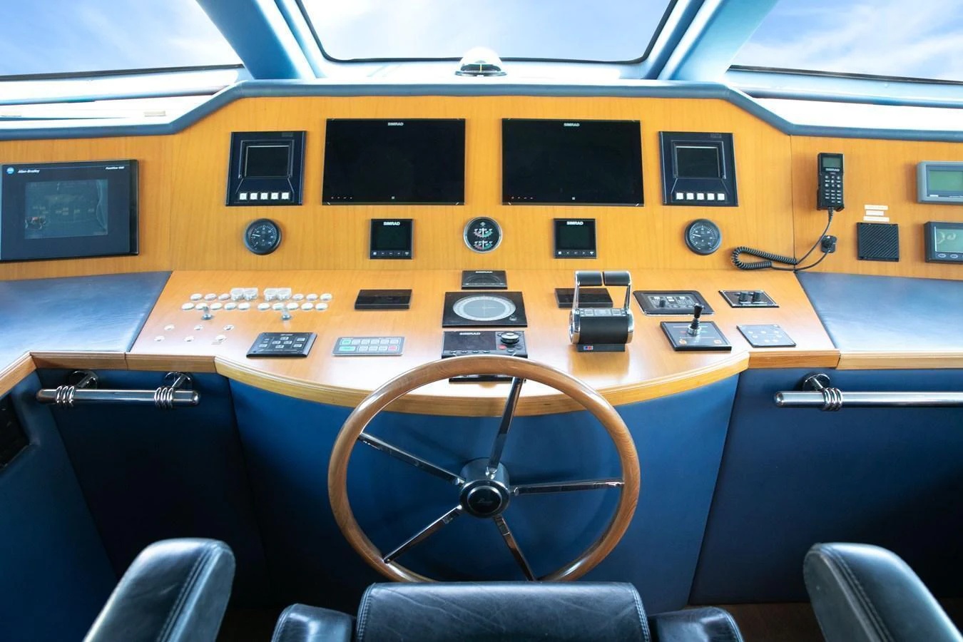 The helm station features advanced navigation equipment and a classic wooden steering wheel. aboard ANYPA Yacht for Sale