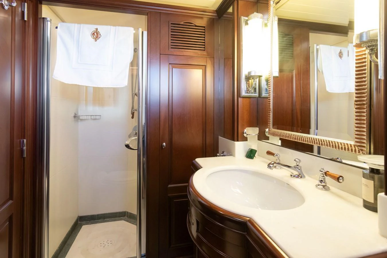 The yacht's bathroom features elegant wooden cabinetry and a spacious shower area. aboard ANYPA Yacht for Sale