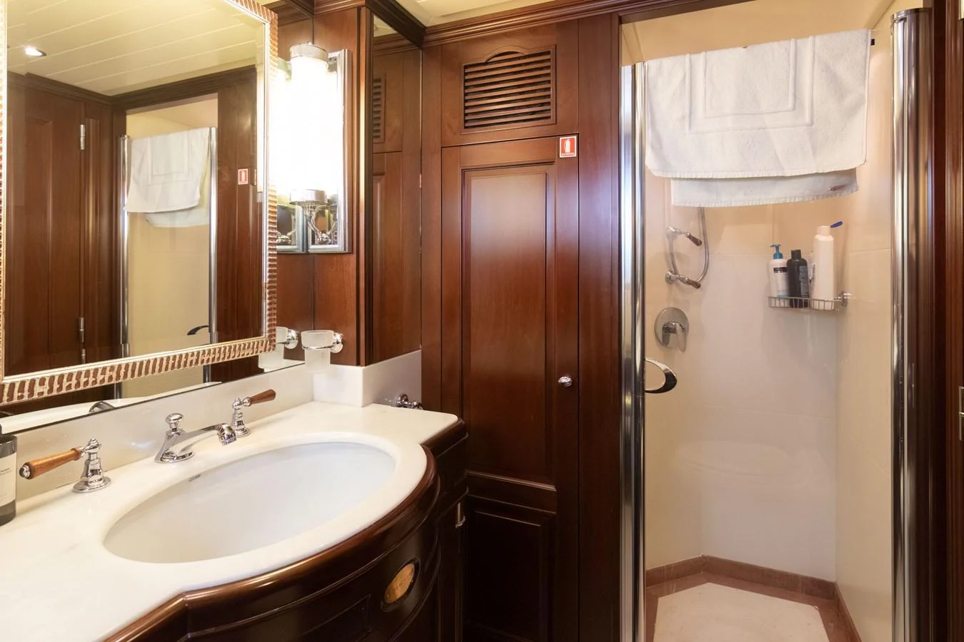 The yacht's bathroom features elegant wood paneling and a spacious shower area. aboard ANYPA Yacht for Sale