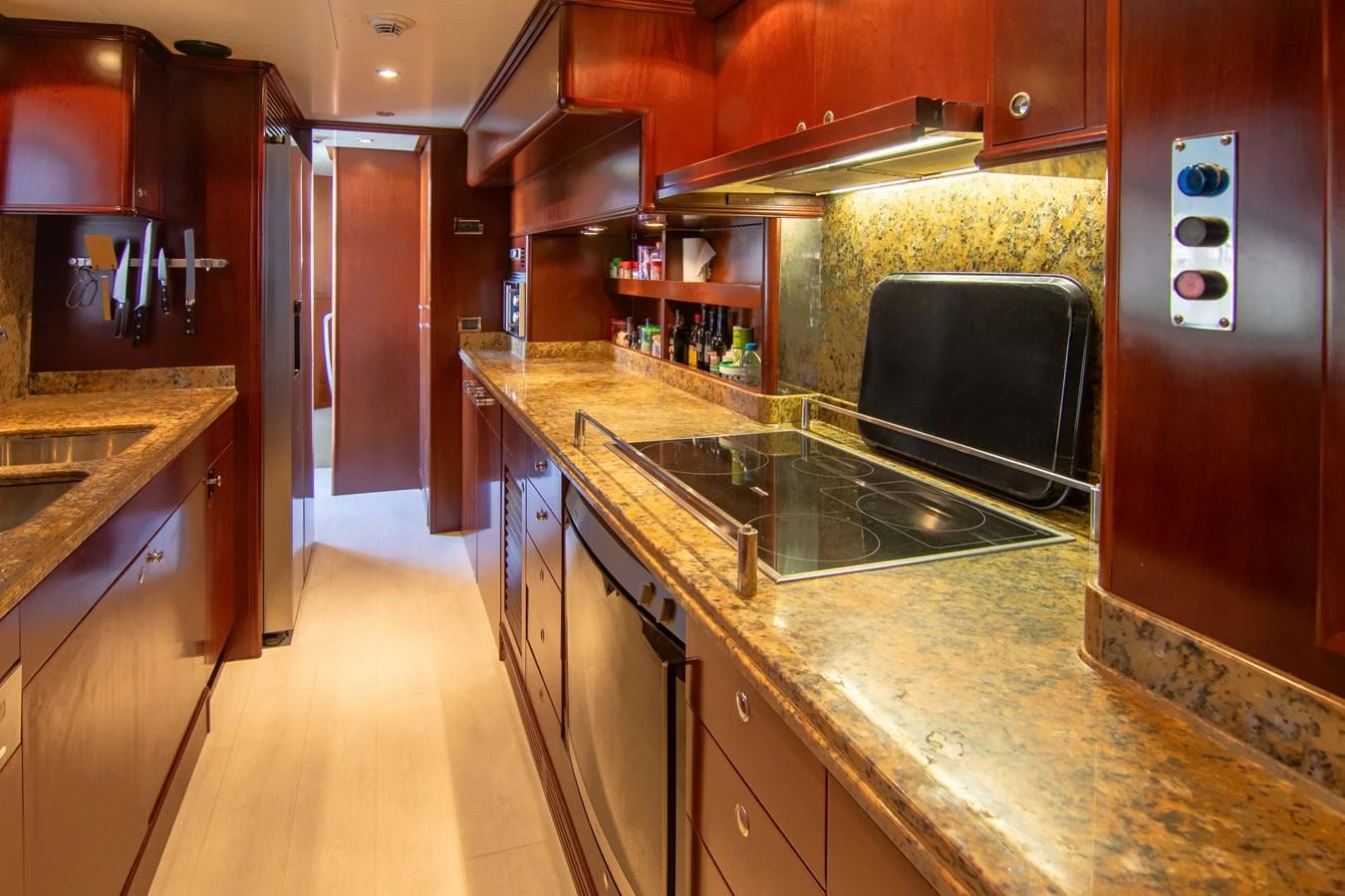 The galley features rich wood cabinetry, modern appliances, and ample counter space. aboard ANYPA Yacht for Sale