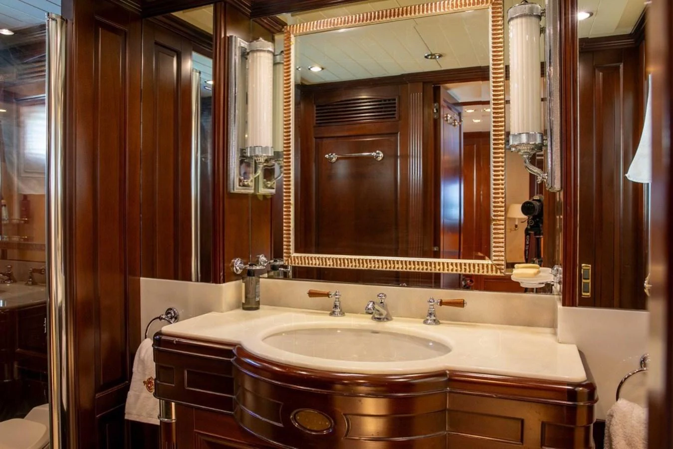 The yacht's bathroom features elegant wooden cabinetry and a luxurious marble countertop. aboard ANYPA Yacht for Sale