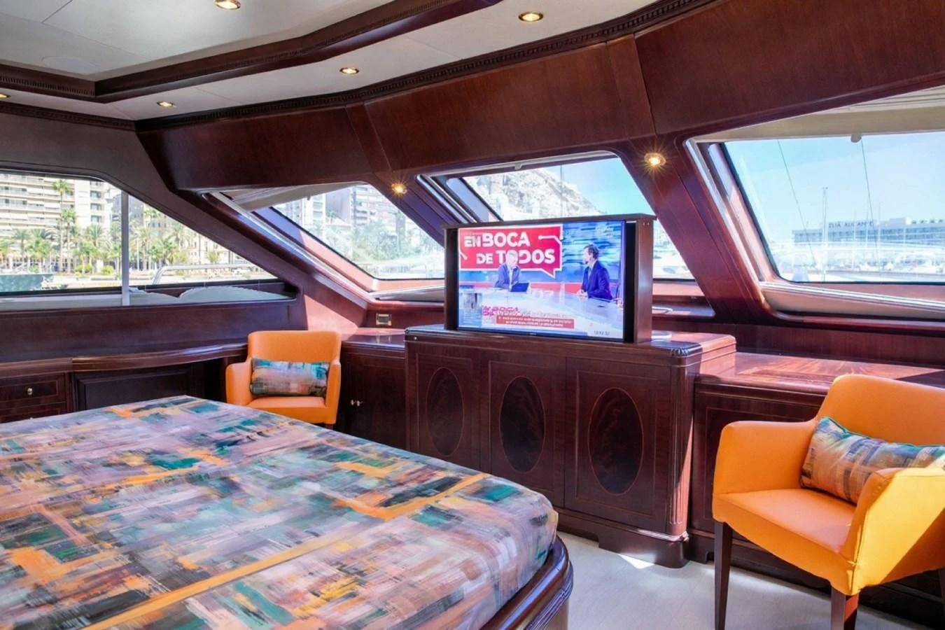 The stateroom features a comfortable bed, a television, and large windows offering scenic views. aboard ANYPA Yacht for Sale
