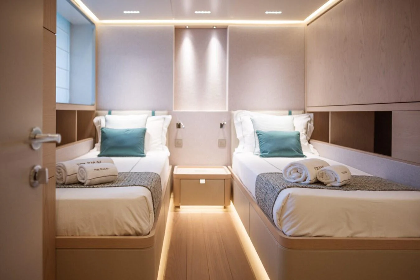 The guest stateroom features twin beds with elegant bedding and soft ambient lighting. aboard TOLEMAI Yacht for Sale