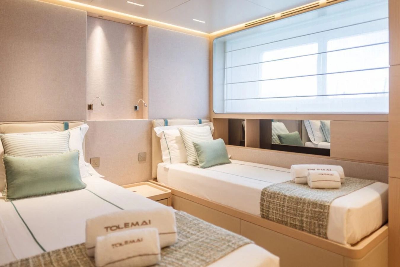 The twin stateroom offers a serene and comfortable retreat with modern furnishings and soft lighting. aboard TOLEMAI Yacht for Sale