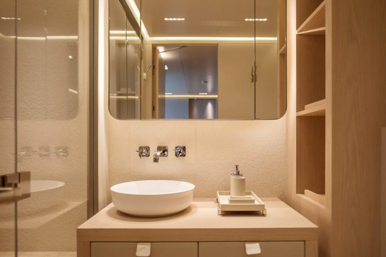The yacht's bathroom features a modern design with a sleek sink and ample storage. aboard TOLEMAI Yacht for Sale