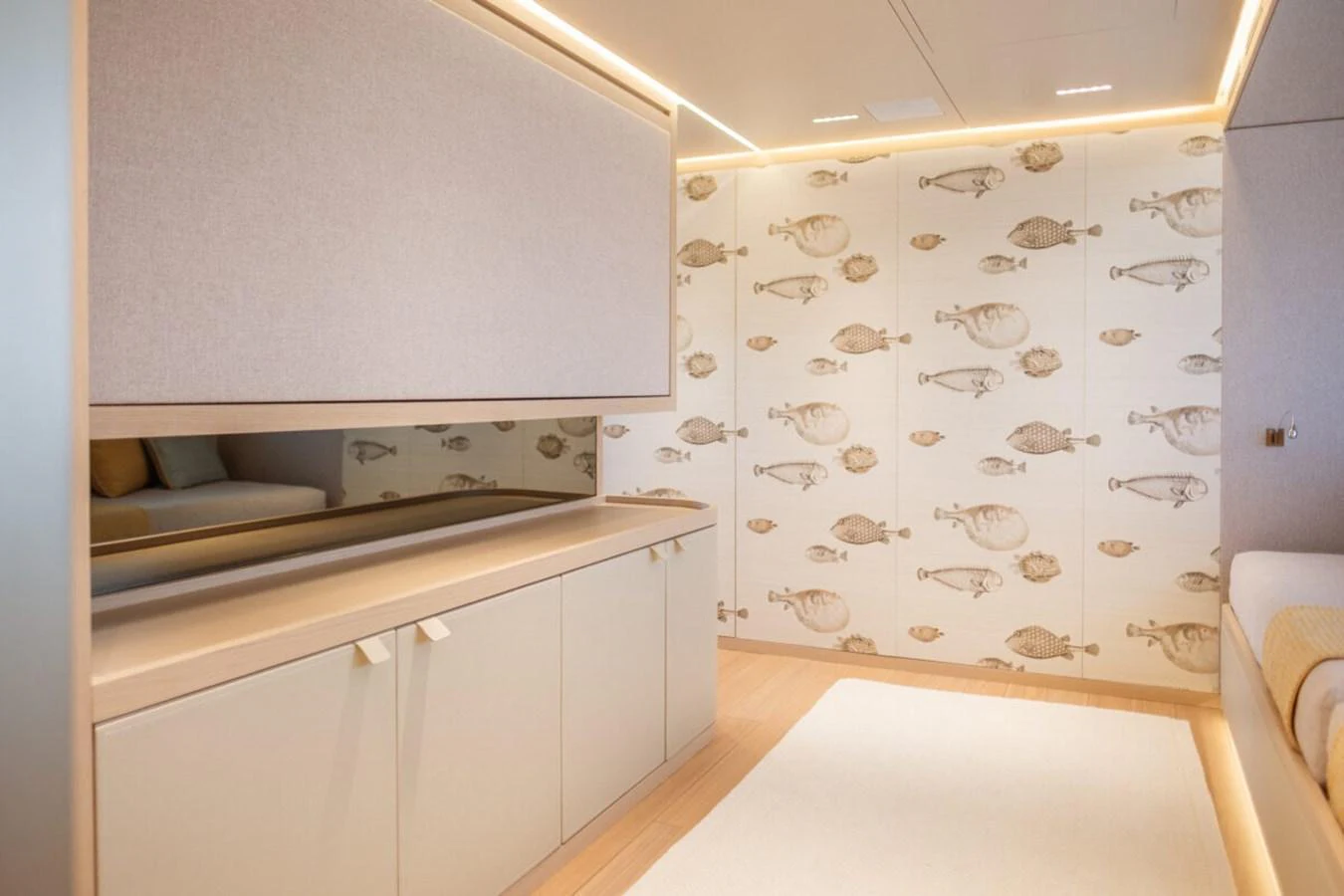 The stateroom features elegant cabinetry and unique fish-themed wall decor. aboard TOLEMAI Yacht for Sale