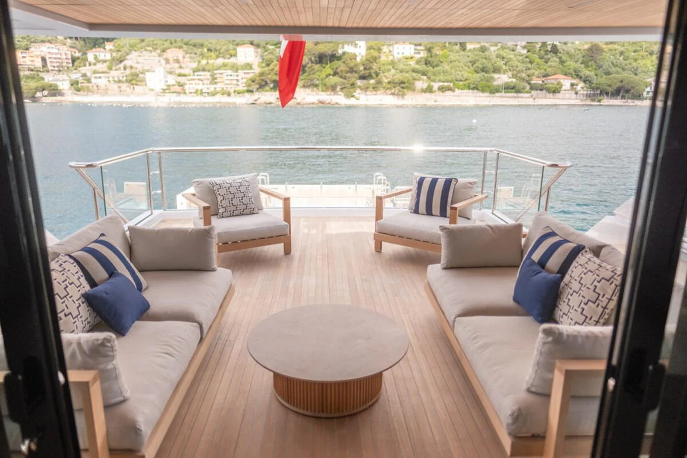 The aft deck features a spacious seating area with plush cushions and a stunning view of the water. aboard TOLEMAI Yacht for Sale