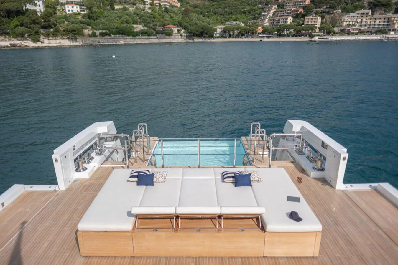 The aft deck features a luxurious lounging area with a stunning view of the water. aboard TOLEMAI Yacht for Sale
